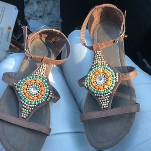 A pair of brown sandals with colored top !!!!